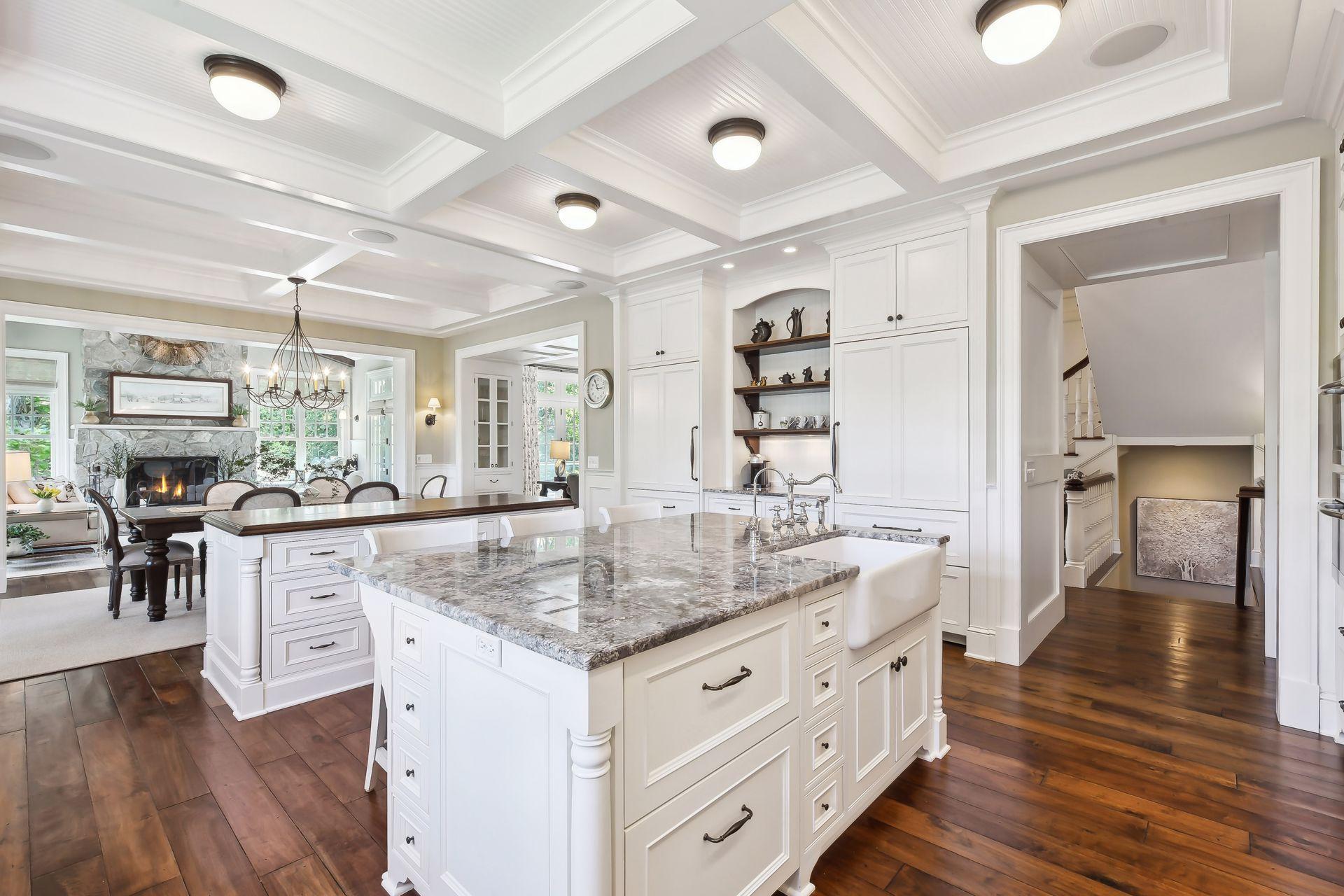 The granite topped island with a Shaw's Original farmhouse apron sink houses two SubZero refrigerator drawers - perfect for keeping your ingredients crisp!