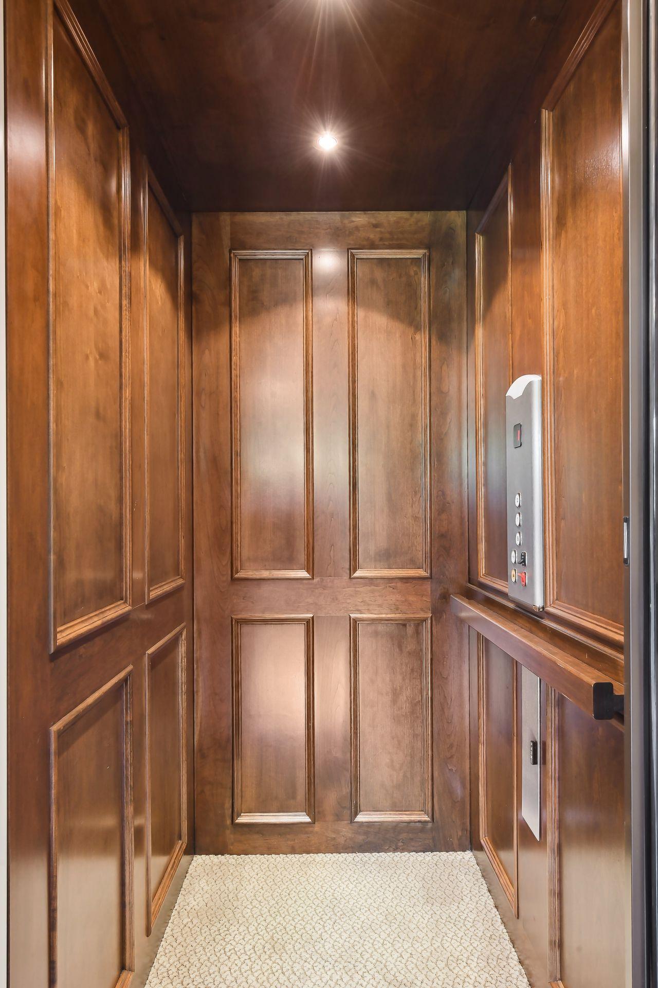 An interior cherry wood, Thyssenkrupp elevator services all three levels of the home.