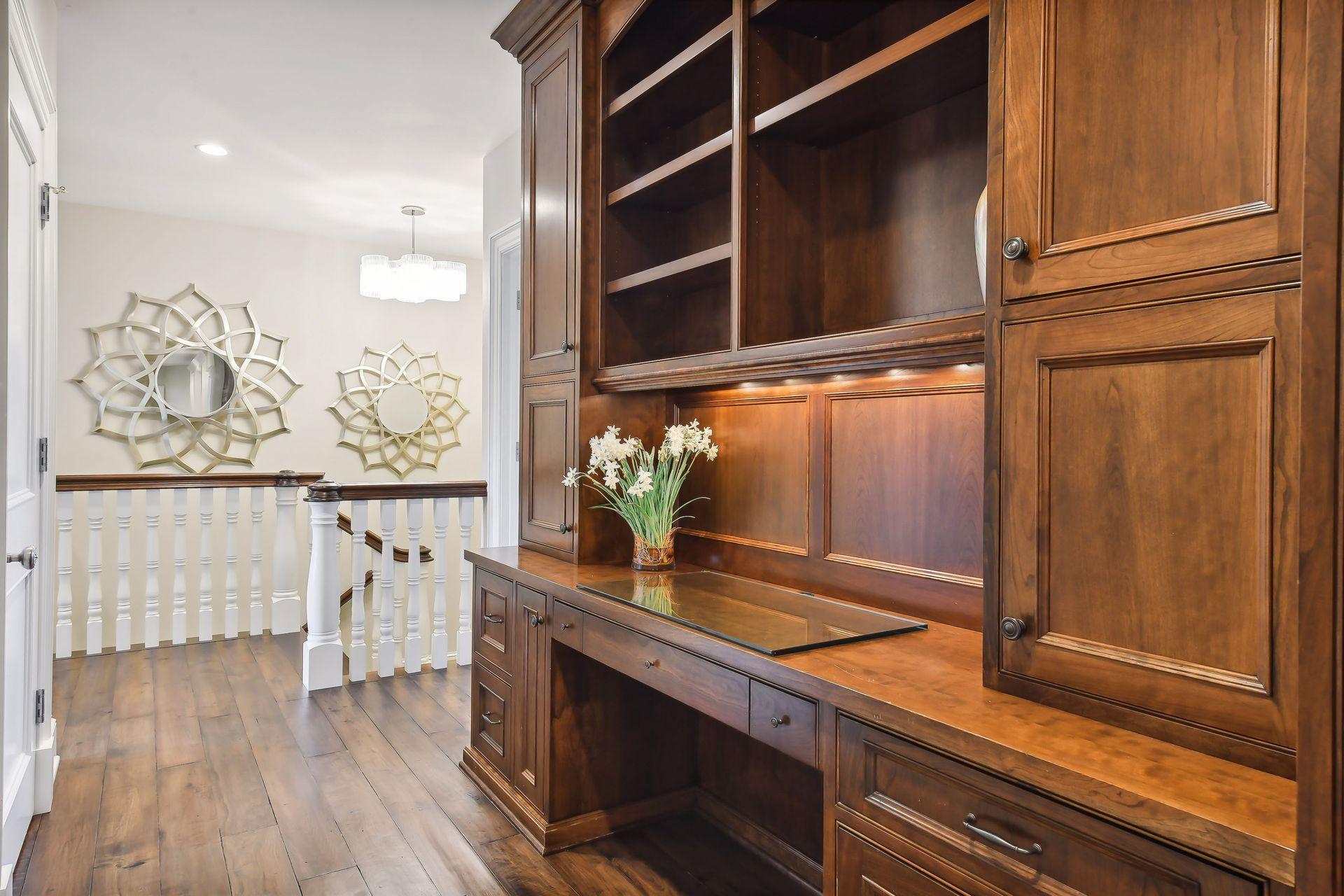 A well-equipped homework desk is located in the upper level hallway and features custom file drawers and a printer cabinet.