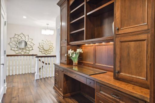 A well-equipped homework desk is located in the upper level hallway and features custom file drawers and a printer cabinet.