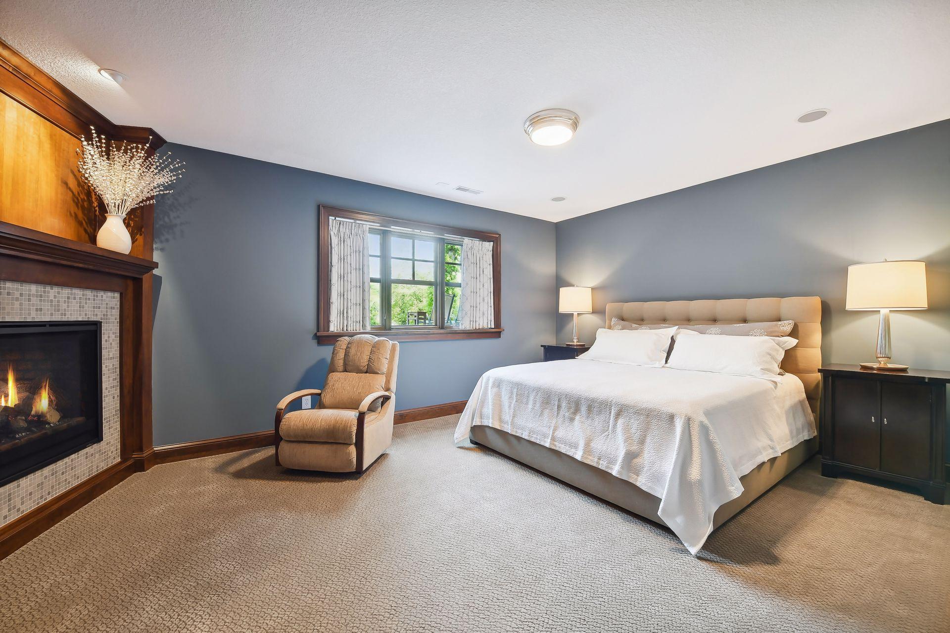 Offering a gas fireplace and built-in entertainment center, the lower level Guest Room is comfortable and inviting. The space also enjoys a walk-in closet with custom organizer system.