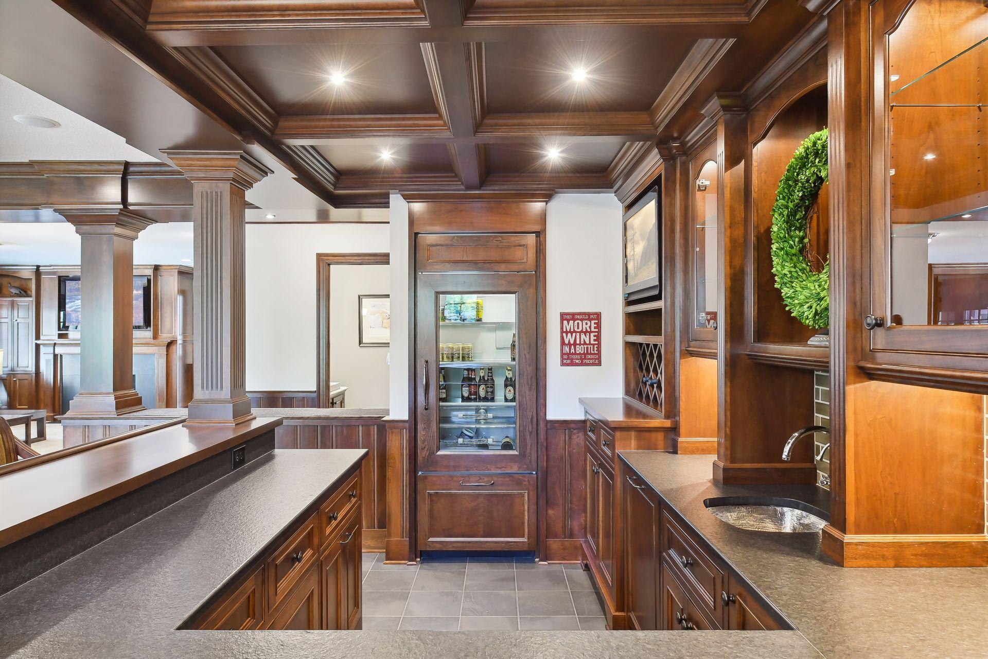 The bar is a work of art with custom cherry cabinetry, leatherized granite countertop and SubZero glass front refrigerator and freezer, a SubZero ice maker and Asko dishwasher.