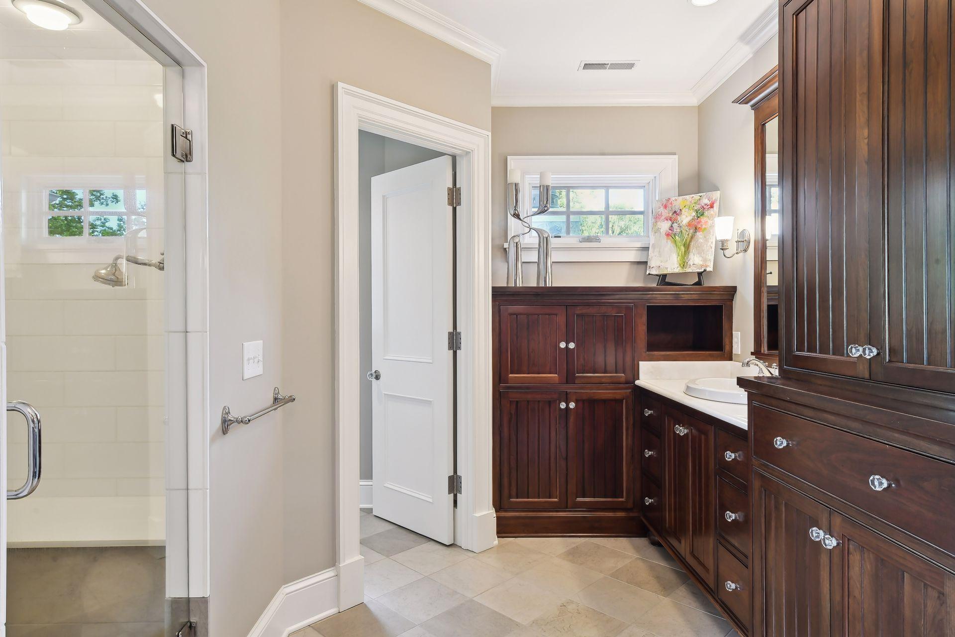 A custom cabinet can store your TV and additional linens.