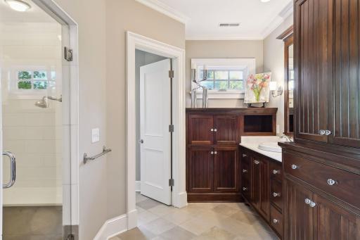 A custom cabinet can store your TV and additional linens.