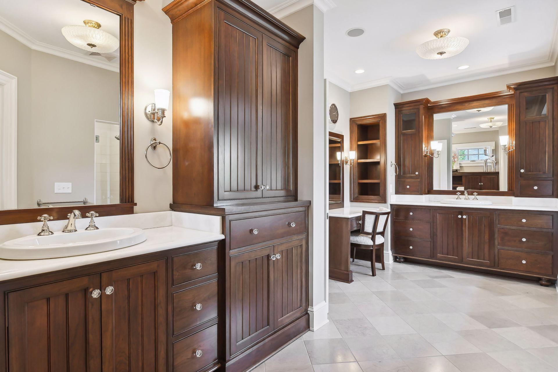 A luxurious bathroom! The Primary Bath features tiled flooring with in-floor heat and vanities with extensive cabinetry.