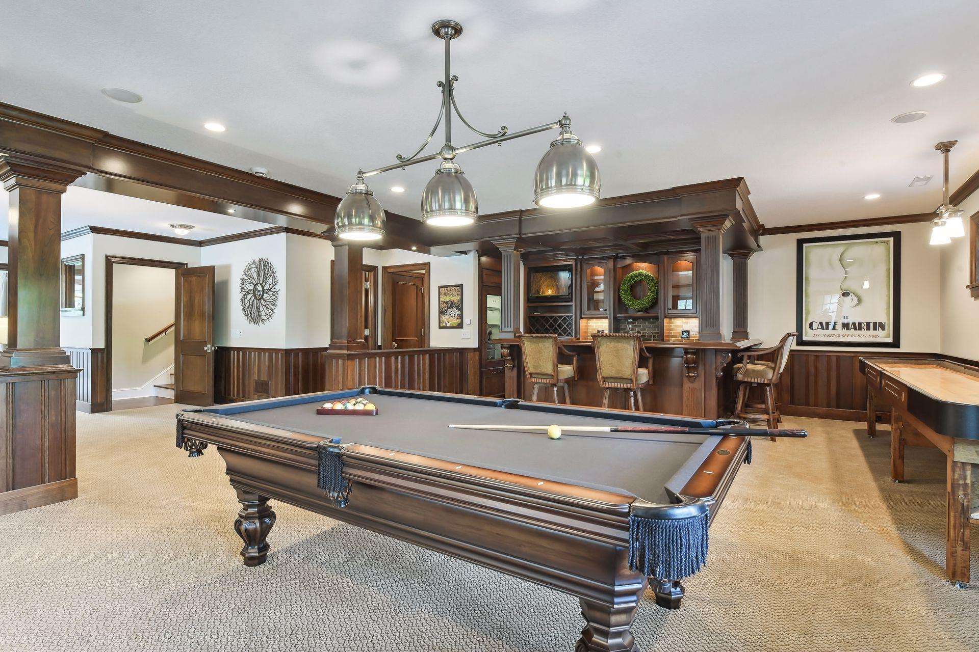 Game night takes on a whole new meaning when you enter the Billiard Room! Complete with a custom shuffle board table and stunning pub-style bar, this will become a favorite gathering place.