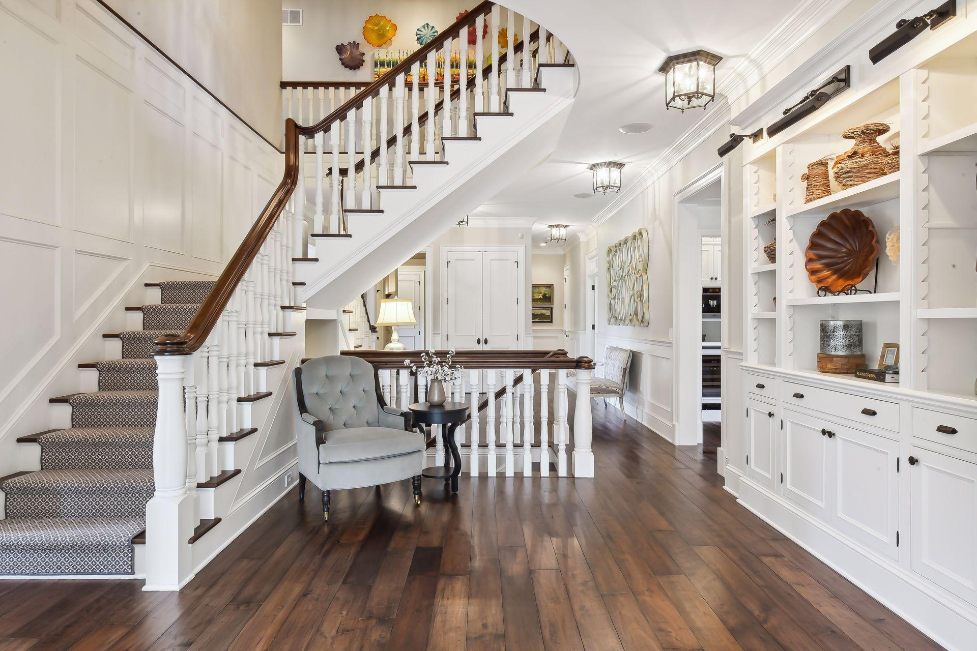 Custom hand-scraped walnut floors with French bleed edges flow throughout the main level where you will find the main hallway with it's built-in bookcases featuring adjustable-height cleated shelving and display lighting.