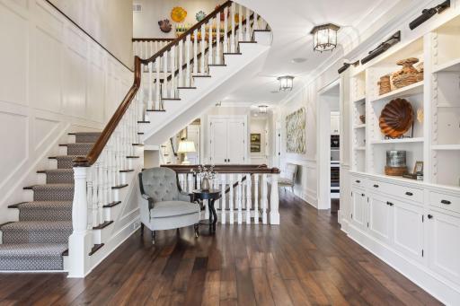 Custom hand-scraped walnut floors with French bleed edges flow throughout the main level where you will find the main hallway with it's built-in bookcases featuring adjustable-height cleated shelving and display lighting.