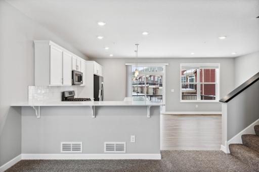 Photo for 7540 38th Street N, Oakdale, MN 55128 - Listing #6368259 Kitchen overlooks dining and family room. Photos are not of actual home. Actual home will be similar. Some colors and features may vary.