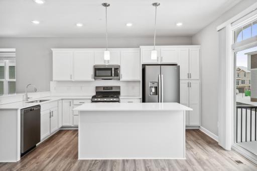 Photo for 7540 38th Street N, Oakdale, MN 55128 - Listing #6368259 Plenty of cabinets for storage and a large center island. Photos are not of actual home. Actual home will be similar. Some colors and features may vary.
