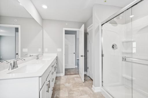 Photo for 7540 38th Street N, Oakdale, MN 55128 - Listing #6368259 Private owner's suite bath with double sinks and a linen closet. Photos are not of actual home. Actual home will be similar. Some colors and features may vary.
