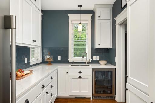On the right is a floor to ceiling wall pantry with soft-close doors. This is the perfect space to house your small appliances, food and backstock. Store your favorite wine/beverages in the built-in refrigerator.