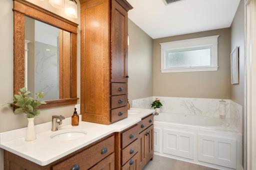Spa-like private bathroom featuring this 2-person jetted Jacuzzi ANZA Salon Spa Whirlpool with bubbler air, heat and spa lighting (Chromatherapy). Wavy ceramic tile surround matches the tile in the walk-in shower.