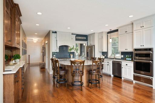 If you like to cook and entertain, you will love this exquisite white-enameled kitchen with custom built solid oak center island, built-in buffet and bonus Sous Chef pantry.