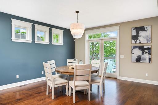 Gorgeous enameled wide window trim w/ crown, stool & apron throughout the main floor & in the lower level office. This informal dining room has space for a hutch, larger table, & you may want to add a porch or deck thru the patio door in the future.