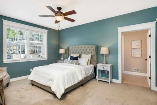 Main floor primary bedroom with private spa-like bathroom and spacious walk-in closet.