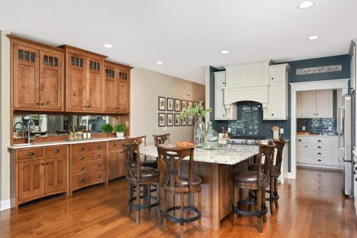 Custom built quarter sawn solid oak buffet cabinet with inset doors & drawers, quartz countertop, framed beveled mirror backsplash, Blanco granite car sink, and soft-close doors & drawers with pullouts.