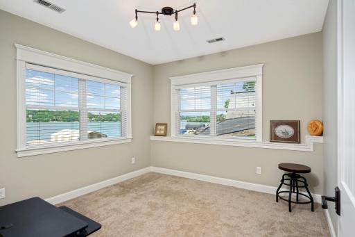 The walkout lower level is mostly unfinished with the exception of this lakeside home office and partially finished craft/gift wrapping station/sewing room/workout room. Who wouldn't want to work from home with this view of the lake!