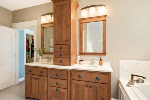 Dual vanity with center tower, soft-close drawers & doors w/ pullout shelves & tip-outs in front of sinks. Notice the matching mission style mirrors. Not pictured is a TOTO Bidet w/ heated seat & remote control in the water closet.