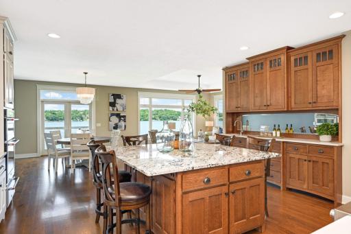 Spacious center island has an plenty of storage, can seat up to 8 chairs, and there is electrical wiring in the ceiling above to add pendant lights if desired.