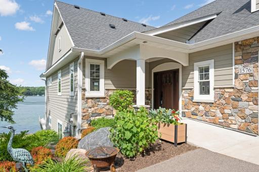 No stairs to enter the home. Exterior features LP siding with stone trim, Marvin Ultrex fiberglass windows, covered gutters on all sides with buried downspouts, insulated fiber-glass front door and stained wainscoting porch ceiling.
