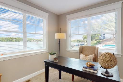 Main floor office offers breathtaking lake views. This is one of two lakeside home offices in the home. Use this space as an office, or open up the wall on the right to expand the primary bedroom.