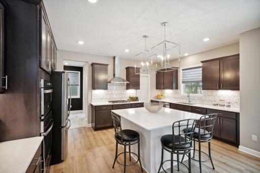 Photo for 6613 Coach House Lane, Corcoran, MN 55340 - Listing #6369342 Another view of the Gourmet kitchen with ample cabinet space. Photo is of model home. Color and finish can vary.