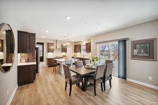 Photo for 6613 Coach House Lane, Corcoran, MN 55340 - Listing #6369342 Open concept main level seamless connects the adjoining dining area. Photo is of model home. Color and finish can vary.