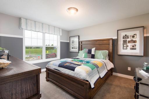 Each of the secondary bedrooms is nicely sized and features a walk-in closet. Photo is of model home. Color and finish can vary.