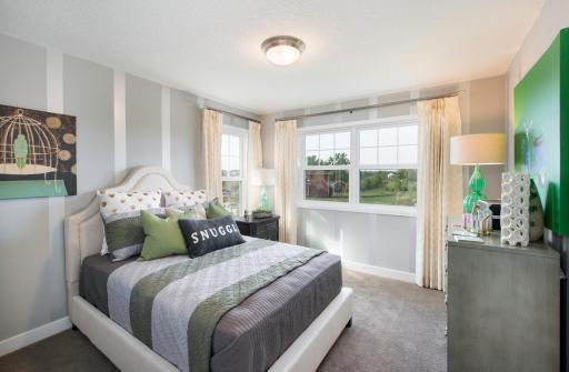 Each of the secondary bedrooms is nicely sized and features a walk-in closet. Notice all the natural light with generous use of windows. Photo is of model home. Color and finish can vary.