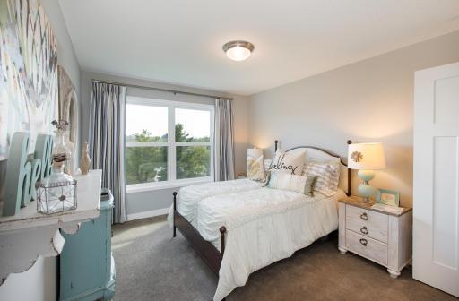Each of the secondary bedrooms is nicely sized and features a walk-in closet. Photo is of model home. Color and finish can vary.