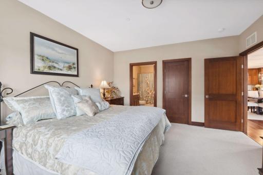 This bedroom offers an ensuite full bath and walk-in closet