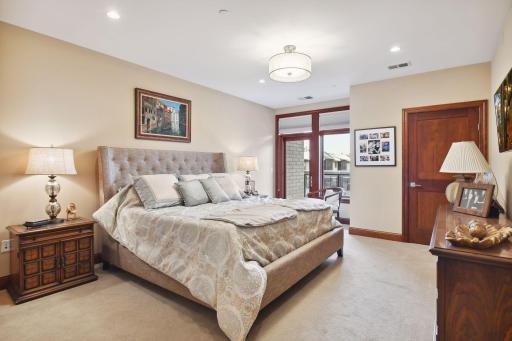 Spacious primary bedroom with balcony access