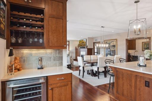 A small butler's counter with wine refrigerator tucked just off the kitchen comes in handy when entertaining