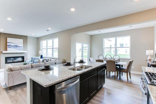 The kitchen space also features this center-island, which can comfortably accommodate four bar stools and serves as the centerpiece to the space! (Photos of the same floorplan, colors will vary)