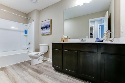 The upper level also includes this oversized full bathroom, which resides just adjacent to the layouts three secondary bedrooms! (Photo of same plan, colors will vary)