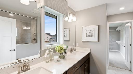 The beautiful primary suite bath also has a large, tiled walk in shower. *Please note, photos are not of actual home, but of a model. Colors and features will vary in actual home.