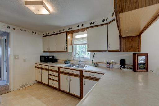 Plenty of counter space and a kitchen window to peek outside while at the sink