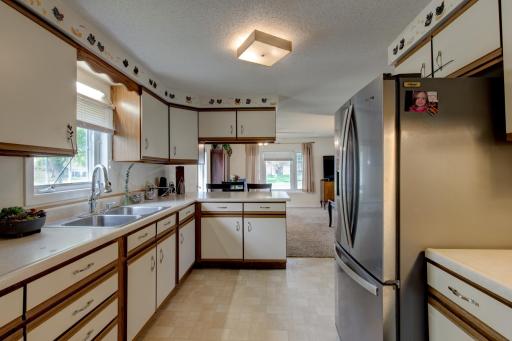 Looking through the length of the kitchen - overhanging cabinets above the island