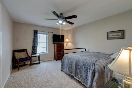 Primary bedroom is a bit larger than the other bedroom and has a functioning ceiling fan