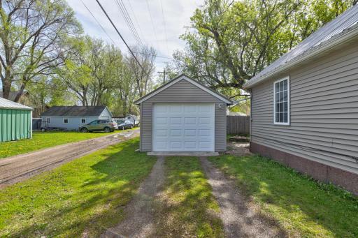 The detached garage and an entrance to the backyard