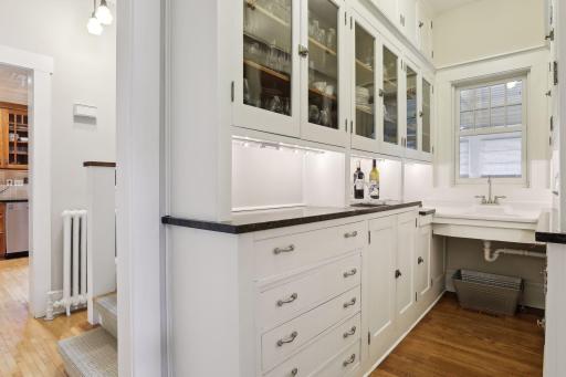 A âbutlerâs pantryâ with sink, workspace and cabinets joins the kitchen to the dining room for serving holiday dinners!