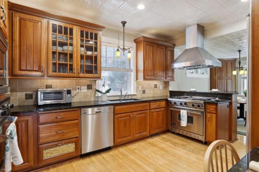 The dream kitchen will delight the cook, complete with abundant glowing cabinetry and expanses of granite-topped workspace.