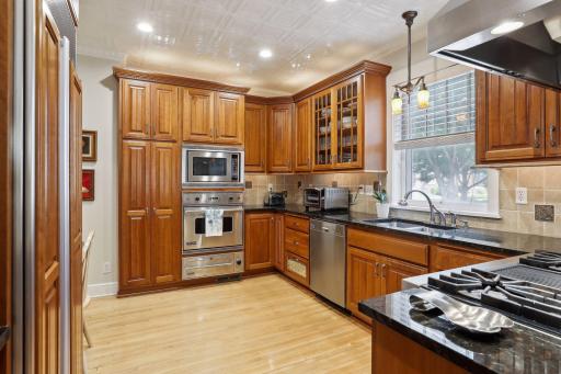 High-end stainless steel appliances include a Viking stove with exhaust fan, a Subzero refrigerator, a Miele dishwasher, and double wall ovens.