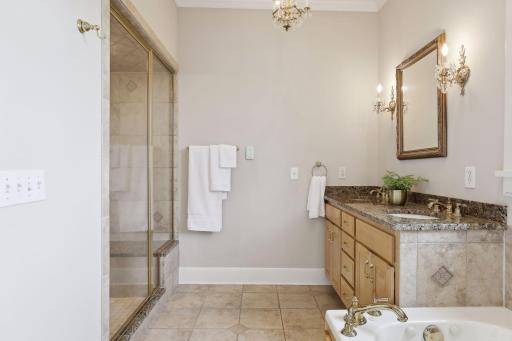 The private full bath is accented with a steam shower with two shower heads.