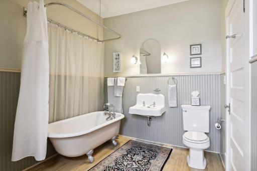 The third level bedrooms share a full bath with a classic clawfoot tub and a large linen closet nearby.