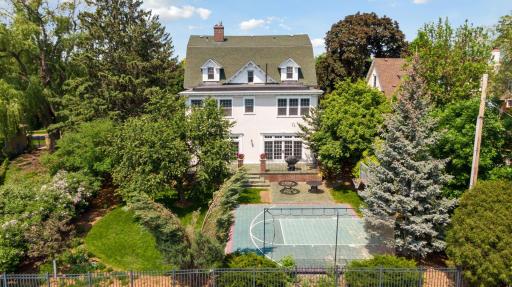 This incredible home is surrounded by lush landscaping and is screened by trees.