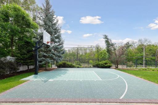 The large backyard is fenced and features a full sport court. Imagine the fun times you'll have here!