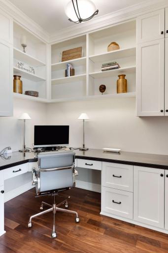 Pocket office located off the kitchen has ample workspace and storage to keep papers and files organized