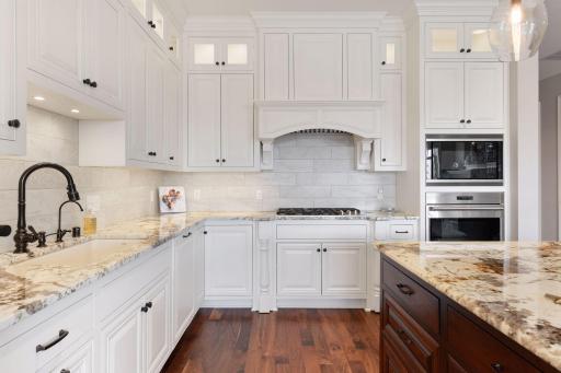 Kitchen highlights include a large center island, granite tops, gas cooktop, and great cabinet space for storage